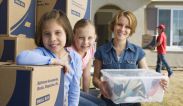 A woman and her two daughters helping pack.